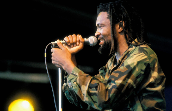 South African reggae icon Lucky Dube singing live into a microphone on stage
